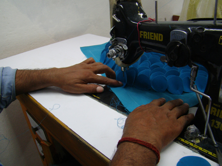 Layered blue organza petals being assembled.