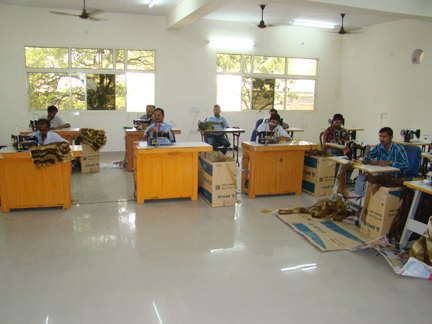 Our embroidery workshop, with artisans at sewing machines.